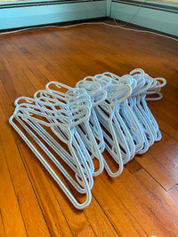 25 white plastic hangers for $15