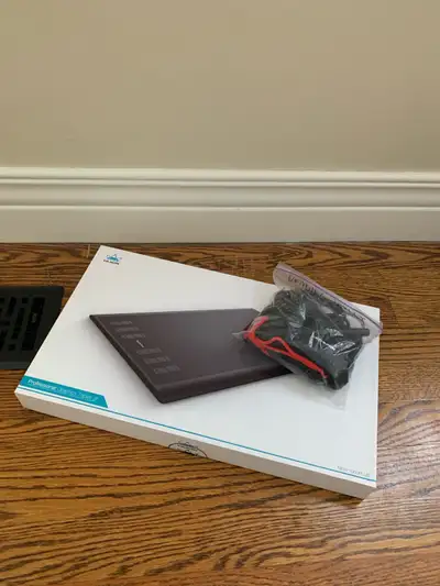 For sale is a Huion drawing tablet, perfect for digital artists and designers. This tablet is in use...