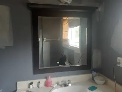 This used bathroom mirror features a dark brown frame and is in good condition, ready to add a touch...
