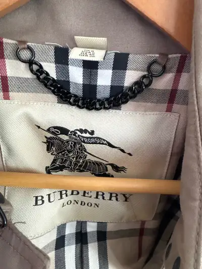 This is a classic Burberry trench coat, perfect for those drizzly days or adding a touch of elegance...