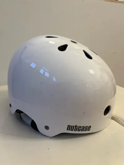This is a used Nutcase bike helmet, perfect for ensuring safety during your rides. It features a con...
