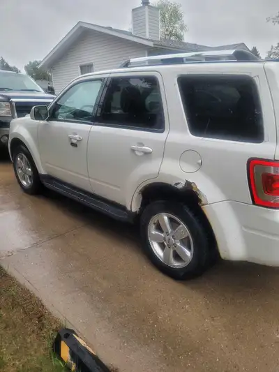 2012 ford escape has hood dent and some hail damage and rust on back wheel wells which all of them d...