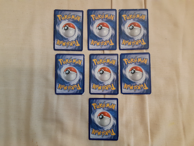 Set of 7 random Pokemon trading cards from various years. Opened set will have no duplicates and 2 u...