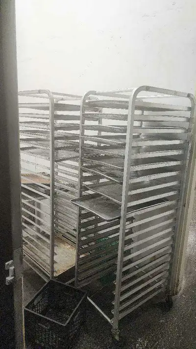 This listing features two commercial baking racks, each equipped with multiple tray slots, ideal for...