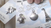 4 silver plated charms never opened NEW in plastic.