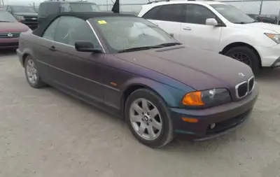 2000 BMW 323 CI Salvage title. Black color under the wrap (half uncovered). Damaged door is replaced...