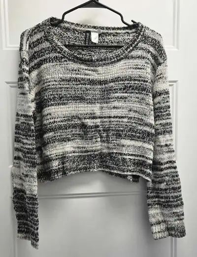 Add a stylish touch to your wardrobe with this H&M sweater, featuring a unique black and white patte...