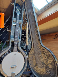 5 string banjo with accessories.