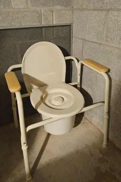 This is a portable bedside commode. It is a medical device designed to assist individuals with mobil...