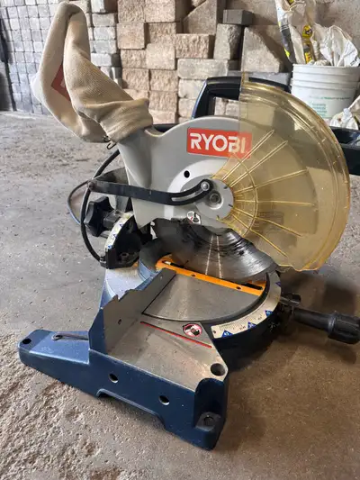 This 10” Ryobi Miter Saw is perfect for various cutting tasks. The plastic guard is slightly damaged...