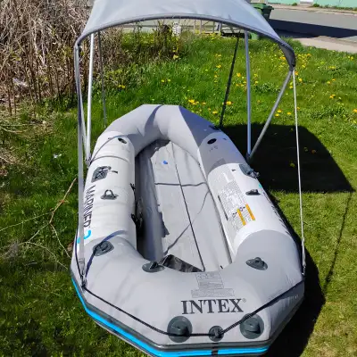 9ft 9in rugged built inflatable boat. Equipped with bimini top, paddles, and pump. Will include cust...