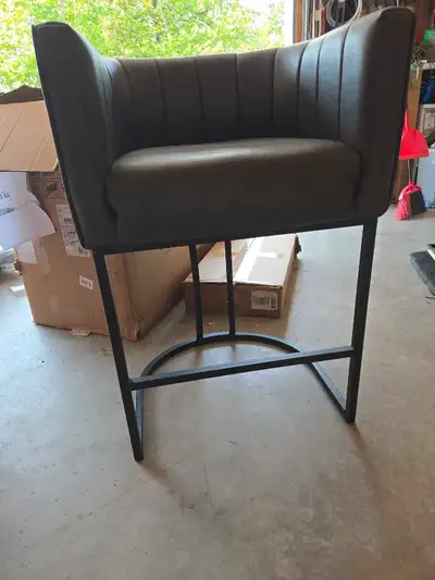 This gray faux leather chair is brand new and ready to add a touch of modern elegance to your space!...