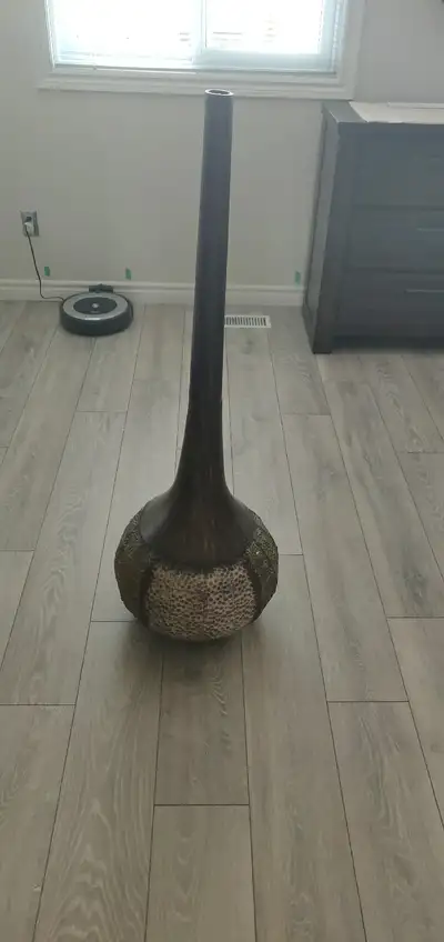 Pier 1 metal floor vase. The height of the floor vase measures 4'.