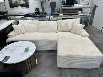 Modern cream L-shape sectional sofa with a soft corduroy-style fabric. Comfortable, low-profile desi...