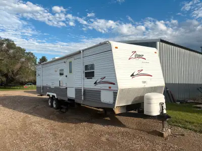 32 foot camper trailer with master bedroom and rear closing kids room Original bunk removed and bunk...