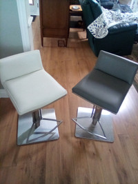 Beautiful faux leather bar stools, one grey, one ivory. $140