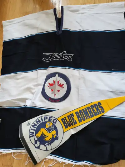 Large Winnipeg Jets Poncho. Never worn. Includes a Blue Bomber flag for a Winnipeg sports fan.