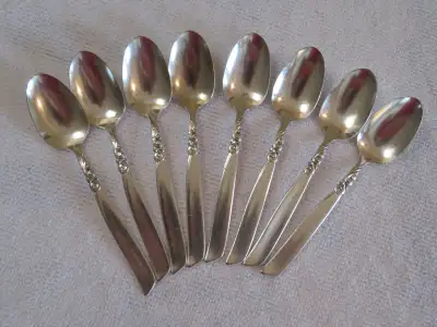 Vintage set of 8 Community Plate by Oneida demitasse spoons, South Seas pattern. The design is a wav...