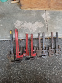 4 pairs of pipe wrenches.  Different sizes.
