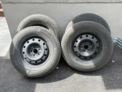 These Michelin X-Ice winter tires, size 225/70 R16, are mounted on steel rims and are ready to provi...