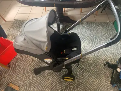 2years old Key Features of the Doona: Integrated Wheels: The Doona has built-in wheels that fold out...