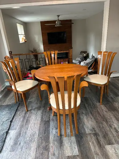 Teak dining table and 4 teak and leather arm chairs.