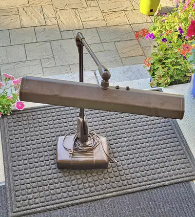 LARGE desk lamp with HEAVY base. Has adjustable arm. Works perfectly. Some minor denting on the top...