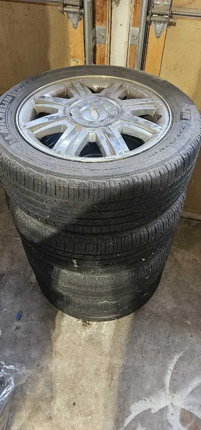 4 chrome rims and caps for Ford Fivehundred. Two tires have a some good tread on them, the other two...