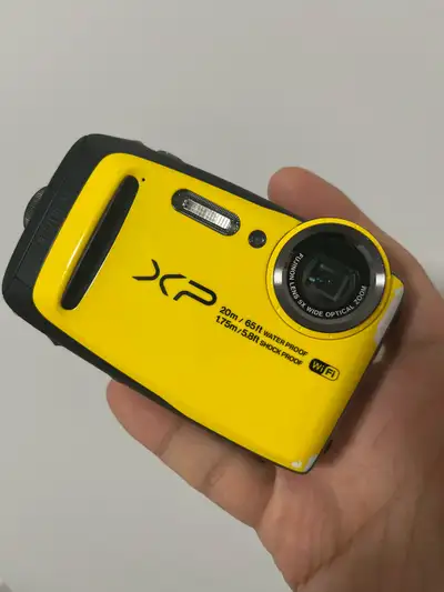 I'm selling a used Fujifilm XP120 waterproof digital camera in yellow, perfect for capturing memorie...