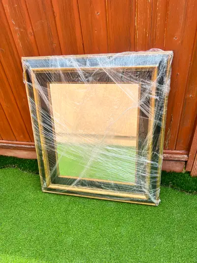 A lovely wooden framed mirror. It's wrapped in plastic, 35”x 31”, View more