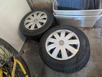 Selling a complete set of 4 winter tires mounted on Volkswagen steel rims with original VW hubcaps....
