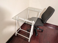 White glass desk with ergonomic office chair