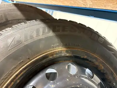 These pre-owned Bridgestone winter tires, size 205/65R16, come mounted on steel rims and are ready t...