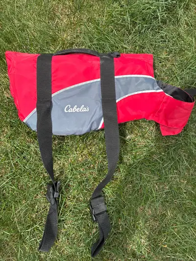 Keep your furry friend safe during water adventures with this Cabela's dog life jacket in a size med...