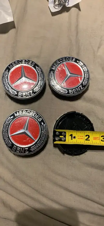 Red and black, 75 mm Mercedes centre caps for rims Brand new in package Check out my ads for other c...