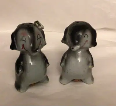 Pair of vintage collectible ceramic salt and pepper shakers shaped like elephants. They are anthropo...