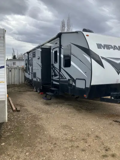 Hardly used. 2019 Keystone Impact 320 Toy Hauler Electric patio awning, 8 cubic foot fridge,12 foot...