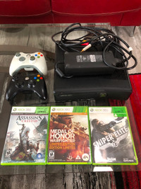 Xbox 360 with two controllers and 3 games