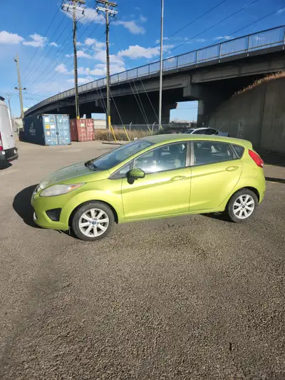 Reliable green 2011 Ford Fiesta with automatic transmission. Runs well and has never given me issues...