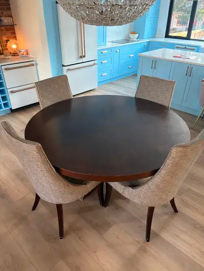 Dark wood kitchen table - 60 inches diameter, 30 inches from floor to top of table. Six grey chairs...