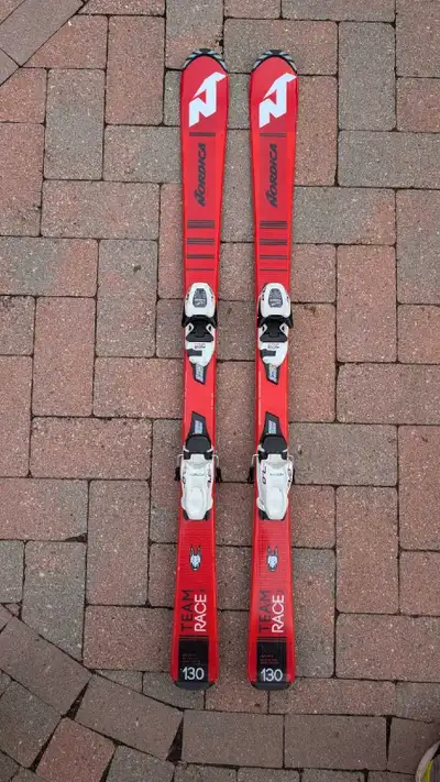 Pair of used Nordica Team Race junior skis. Size 130cm. Equipped with Marker bindings. Great for you...