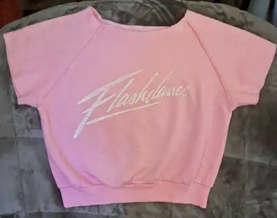 This is a vintage "Flashdance" sweatshirt from 1983, featuring a classic design. The sweatshirt is i...