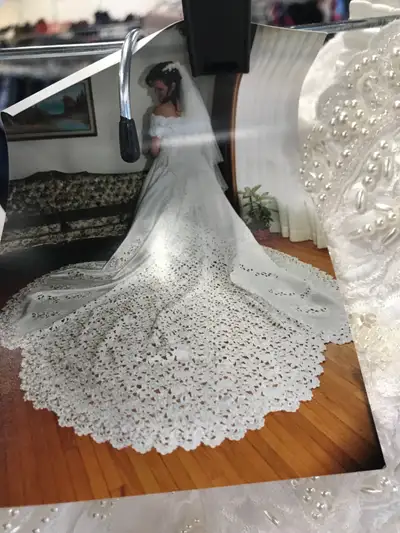 Beautiful white wedding dress with an amazing train with lovely bead work. Size 8, fits up to about...