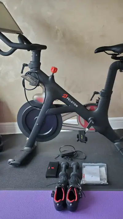 Get ready to elevate your fitness game with this used Peloton Bike! This exercise bike comes with a...