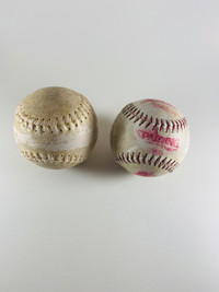 Pair of used softballs for batting practice