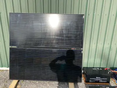 Two 200 W Renogy solar panels, total 400 W. Mounted on a metal frame and wired together with wiring...