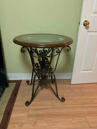 Glass top table with wrought iron legs, very heavy nice table