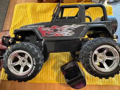 I'm selling a well-loved New Bright Jeep Rubicon remote control truck, complete with two remotes, a...