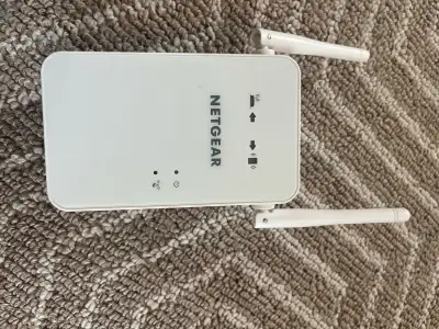 This pre-owned Netgear WiFi range extender is a reliable solution for eliminating dead zones and boo...