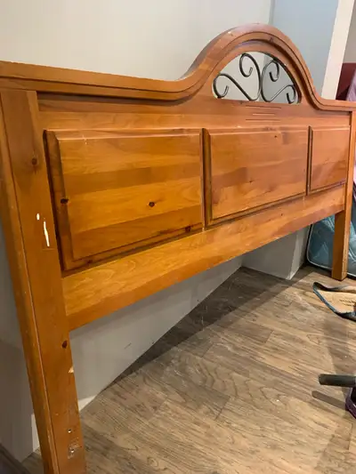 King headboard. Wood and metal. Comes with matching night table and a steel bed frame. $100 or best...
